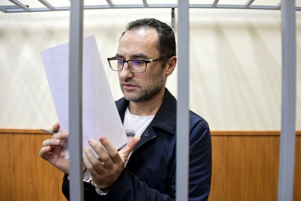 Eugene Spector, Russian-born U.S. citizen already imprisoned in Russia on a bribery conviction has been handed a second 15-year jail term for espionage, stands behind bars in a courtroom in Moscow, Russia, Thursday, Feb. 20, 2020. (Igor' Ivanko/Kommersant Publishing House via AP, File)