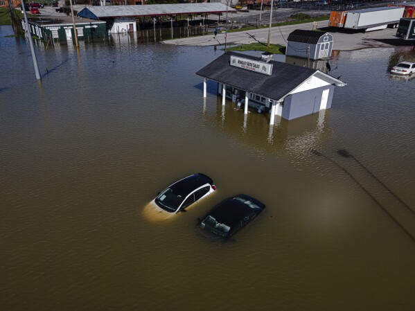 Vehicles are seen within the floodwaters from the Kentucky River on Monday, April 7, 2025, in Frankfort, Ky. (AP Photo/Jon Cherry)