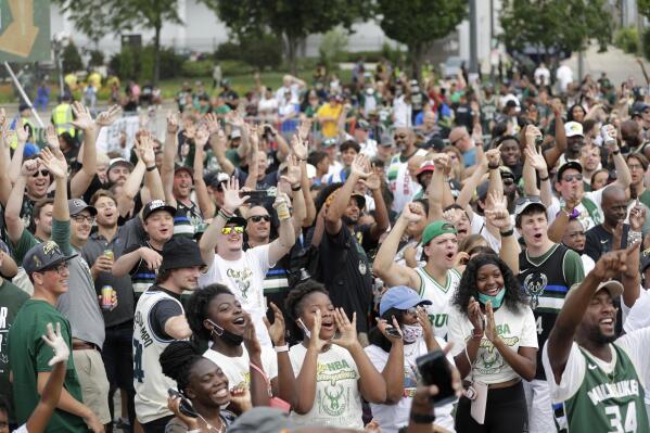 Fans cheer before a parade celebrating the Milwaukee Bucks' NBA Championship basketball team Thursday, July 22, 2021, in Milwaukee. (AP Photo/Aaron Gash)