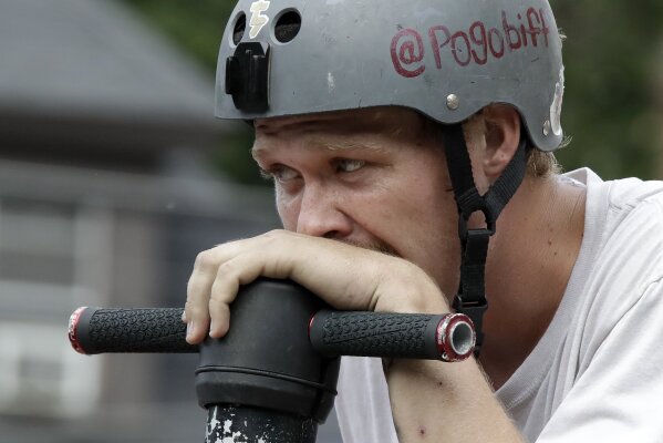 Biff Hutchison, of Burley, Idaho, takes a breather during his performance during Pogopalooza, The World Championships of Pogo in Wilkinsburg, Pa., Saturday, July 20, 2019. (AP Photo/Gene J. Puskar)