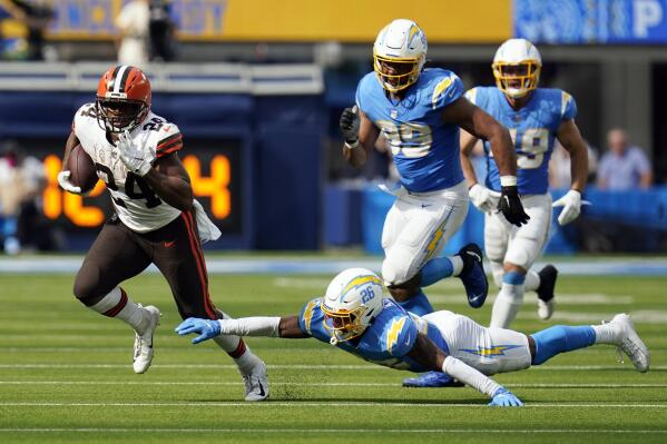 Cleveland Browns running back Nick Chubb runs for a touchdown past the tackle attempt by Los Angeles Chargers cornerback Asante Samuel Jr. (26) during the second half of an NFL football game Sunday, Oct. 10, 2021, in Inglewood, Calif. (AP Photo/Gregory Bull )