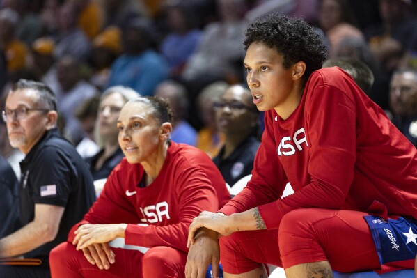FILE - Team USA center Brittany Griner, right, and guard Diana Taurasi, center, watch play during the second half of an NCAA college basketball exhibition game against Tennessee, Sunday, Nov. 5, 2023, in Knoxville, Tenn. The U.S. women's basketball national team will get together for a few days in New York next month before playing in the FIBA Women's Olympic Qualifying Tournament in Belgium. Five-time Olympic champion Diana Taurasi is one of 11 Olympians who will participate in the training camp that will take place at Barclays Center. Joining her will be former Olympians Brittney Griner, Ariel Atkins, Allisha Gray, Chelsea Gray, Jewell Loyd, Kelsey Plum, Breanna Stewart, A'ja Wilson, Jackie Young and Napheesa Collier. (AP Photo/Wade Payne, File)