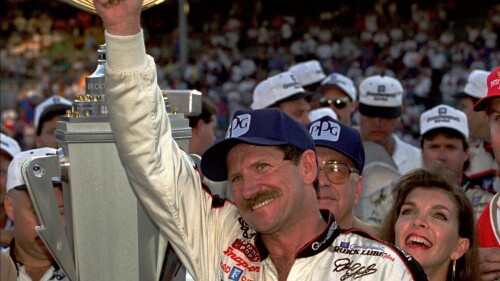 FILE - NASCAR driver Dale Earnhardt of Mooresville, N.C., gestures to the crowd from after winning the Brickyard 500 auto race at Indianapolis Motor Speedway, Saturday, Aug. 5, 1995. To mark NASCAR’s 75th season, The Associated Press interviewed 12 key contributors to the industry on multiple topics. According to the survey, Dale Earnhardt's death in the 2001 Daytona 500 was picked as NASCAR's most pivotal moment. (AP Photo/Tom Strattman, File)