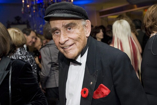 Peter C. Newman is seen during a reception at the 2010 Scotiabank Giller Prize ceremony in Toronto, Tuesday, Nov. 9, 2010. Veteran journalist and author Newman has died at the age of 94, on Thursday, Sept. 7, 2023. In his decades-long career, Newman served as editor-in-chief of the Toronto Star and Maclean’s magazine covering both Canadian politics and business. (Aaron Vincent Elkaim/The Canadian Press via AP)