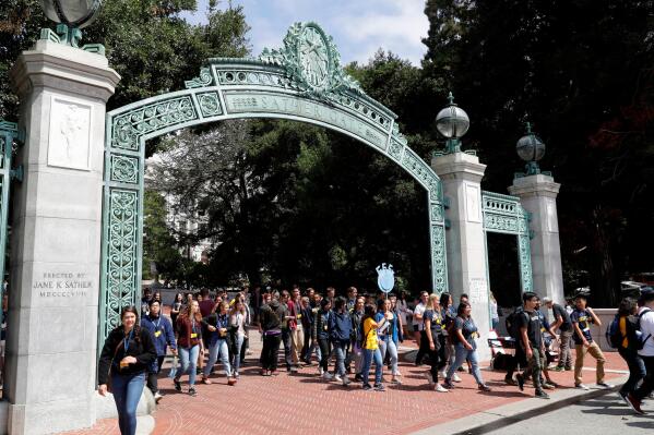 FILE - Students walk on the University of California, Berkeley campus in Berkeley, Calif., on Aug. 15, 2017. A group of residents that successfully challenged the university to limit its undergraduate enrollment offered to allow 1,000 more students in the upcoming academic year. Save Berkeley Neighborhoods said Saturday, March 5, 2022, it's willing to settle a lawsuit with the prestigious public university if UC Berkeley ends its effort to get out from this week's court order to cap enrollment to the 2020-21 school year level. (AP Photo/Marcio Jose Sanchez, File)