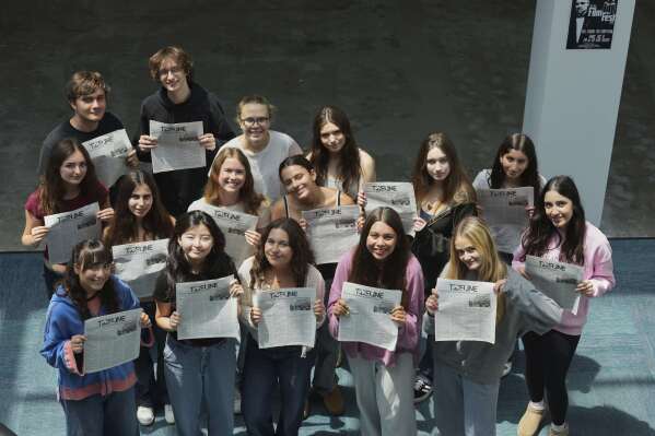 Members of Tideline, the student newspaper, pose for a group photo showing the publication at the interim location for Palisades High School Wednesday, May 14, 2025, in Santa Monica, Calif. (AP Photo/Marcio Jose Sanchez)