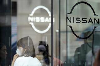 Logos at a Nissan showroom are seen in Ginza shopping district in Tokyo on March 31, 2023. Japanese automaker Nissan reported Thursday, May 11, a seven-fold surge in January-March profit and forecast strong sales for this fiscal year riding on the popularity of its new model offerings. (AP Photo/Eugene Hoshiko)
