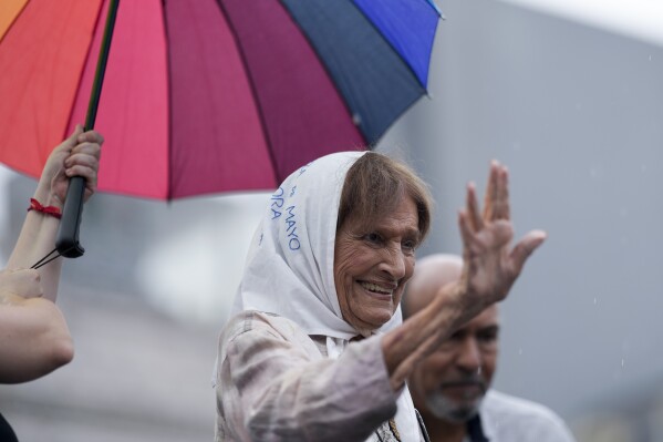 FILE - Taty Almeida waves during an event marking International Women's Day in Buenos Aires, Argentina, March 8, 2024. Almeida's 20-year-old son Alejandro vanished in June 1975. For four years she searched on her own for her son but in 1979 approached the Mothers of Plaza de Mayo, worried that with her family's military background, they would think she was a spy. (AP Photo/Natacha Pisarenko, File)