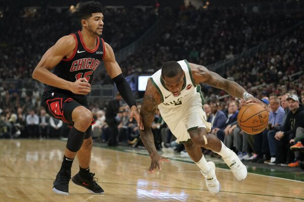 Milwaukee Bucks' Eric Bledsoe drives past Chicago Bulls' Chandler Hutchison during the first half of an NBA basketball game Thursday, Nov. 14, 2019, in Milwaukee. (AP Photo/Morry Gash)