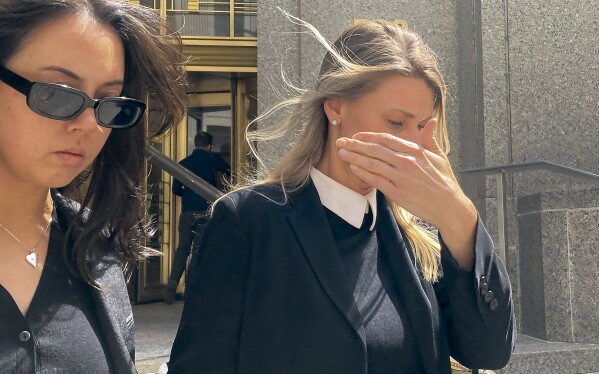 Aimee Harris, right, walks out of Manhattan federal court, Tuesday, April 9, 2024, in New York. The Florida mother has been sentenced to a month in prison and three months of home confinement for stealing and selling President Joe Biden's daughter's diary four years ago. (AP Photo/Larry Neumeister)