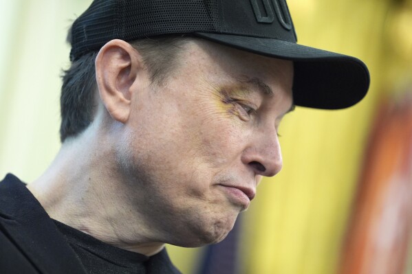 Elon Musk listens as President Donald Trump speaks during a news conference in the Oval Office of the White House, Friday, May 30, 2025, in Washington. (AP Photo/Evan Vucci)