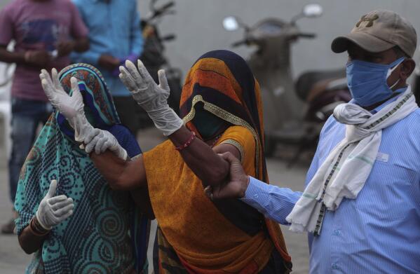 A relative of a patient who died of COVID-19, mourns outside a government COVID-19 hospital in Ahmedabad, India, Tuesday, April 27, 2021. Coronavirus cases in India are surging faster than anywhere else in the world. (AP Photo/Ajit Solanki)