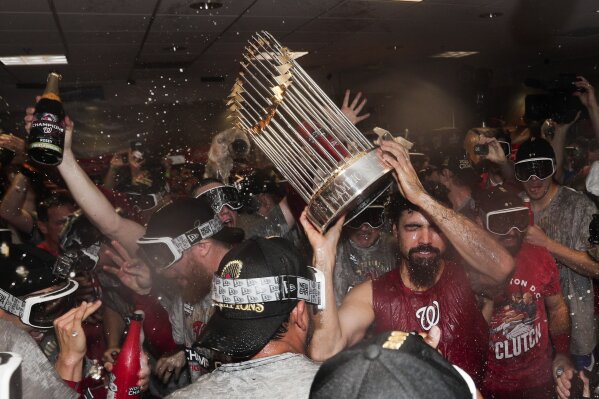 The Washington Nationals celebrate with the trophy after Game 7 of the  baseball World Series against the Houston Astros Wednesday, Oct. 30, 2019,  in Houston. The Nationals won 6-2 to win the