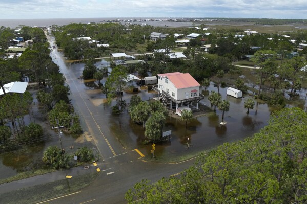 In this photo made in a flight provided by mediccorps.org, receding storm waters surround homes in a community near Keaton Beach, Fla., following the passage of Hurricane Idalia, Wednesday, Aug. 30, 2023. (AP Photo/Rebecca Blackwell)