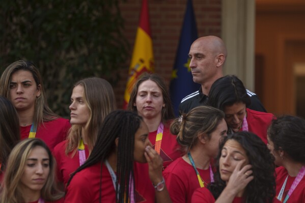 FILE - Then President of Spain's soccer federation, Luis Rubiales, top right, stands with Spain's Women's World Cup soccer team after their World Cup victory at La Moncloa Palace in Madrid, Spain, on Aug. 22, 2023. One day before Spain’s new women’s coach announces her first squad, the players who won the Women’s World Cup have yet to say if they are ready to come back to the team after rebelling against their disgraced former federation president. Spain’s women have had little chance to celebrate their greatest soccer achievement because Luis Rubiales caused an uproar when he kissed a player on the lips without her consent at the awards ceremony last month in Sydney. (AP Photo/Manu Fernandez)