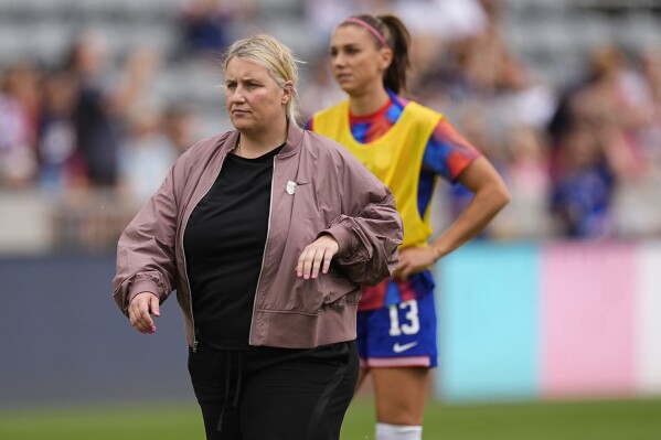  United States women's national team head coach Emma Hayes, left, looks on with forward Alex Morgan (13) as players warm up before facing South Korea in an international friendly soccer game Saturday, June 1, 2024, in Commerce City, Colo. (AP Photo/David Zalubowski)