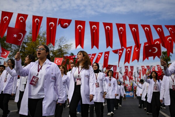Medicine university students take part in a parade during celebrations marking the 100th anniversary of the creation of the modern secular Turkish Republic, in Istanbul, Turkey, Sunday, Oct. 29, 2023. (AP Photo/Emrah Gurel)