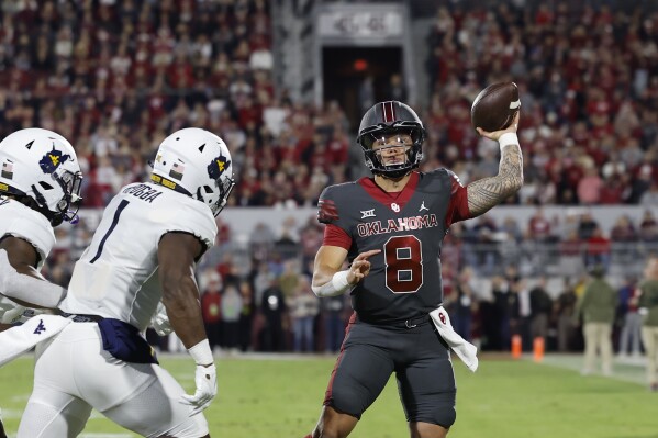 Oklahoma quarterback Dillon Gabriel (8) passes against West Virginia during the first half of an NCAA college football game Saturday, Nov. 11, 2023, in Norman, Okla. (AP Photo/Alonzo Adams)