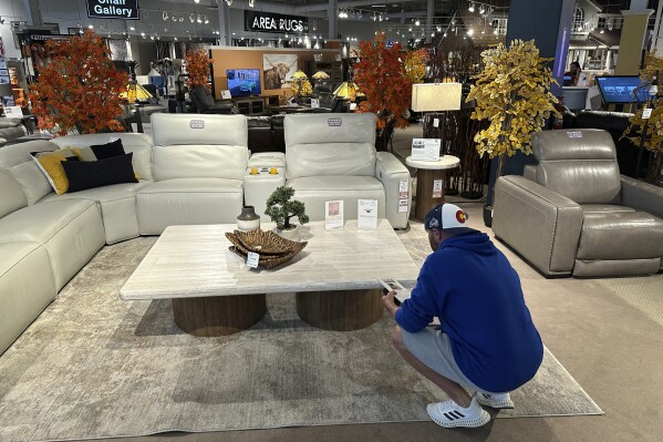 A shopper pauses at a display in a furniture store Sunday, June 2, 2024, in Englewood, Colo. On Wednesday, June 12, 2024, the Labor Department issues its report on prices at the consumer level in May. (AP Photo/David Zalubowski)