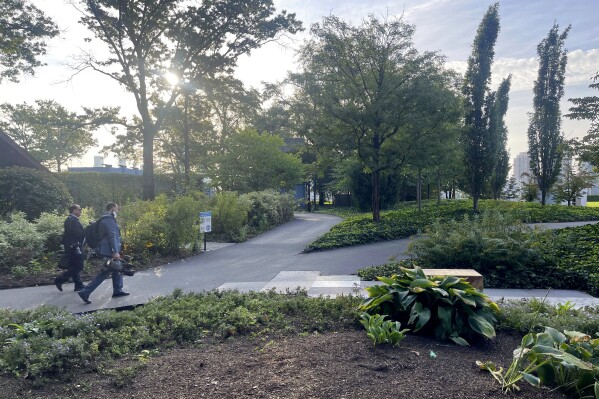 Two journalists walk through a park area on the north end of the United Nations compound (AP Photo/Ted Anthony)