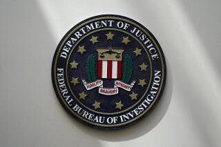 FILE - An FBI seal is seen on a wall on Aug. 10, 2022, in Omaha, Neb. The FBI estimates violent crime rates didn’t increase substantially last year, though they remained above pre-pandemic levels, according to annual crime data released Wednesday, Oct. 6. (AP Photo/Charlie Neibergall, File)