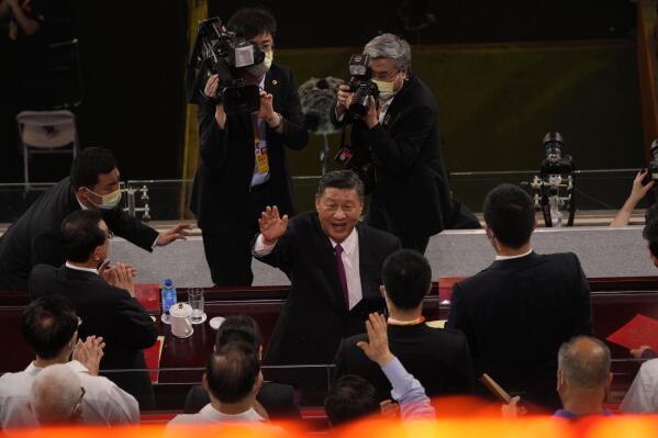 FILE - Chinese President Xi Jinping waves as he attends a gala show ahead of the 100th anniversary of the founding of the Chinese Communist Party in Beijing on June 28, 2021. Chinese President Xi Jinping was the son of a communist revolutionary leader, a victim of the Cultural Revolution and a provincial leader who promoted economic growth before ascending to the very top a decade ago. (AP Photo/Ng Han Guan, File)