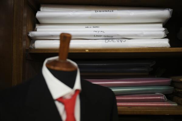 Fabric sits on shelves at the Gammarelli ecclesiastic clothes tailor shop in Rome, Wednesday, April 30, 2025. (AP Photo/Francisco Seco)