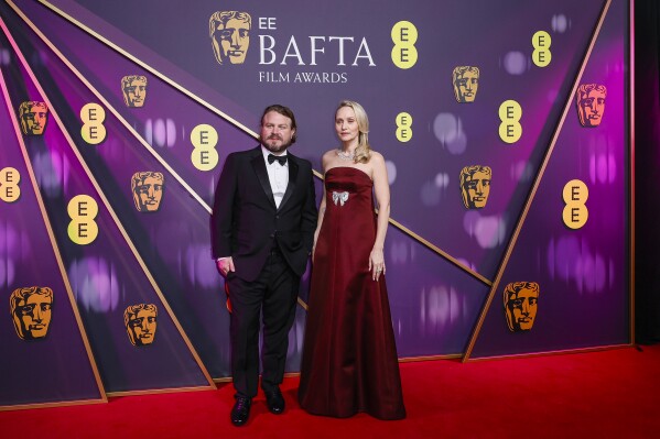 Brady Corbet, left, and Mona Fastvold pose for photographers upon arrival at the 78th British Academy Film Awards, BAFTA's, in London, Sunday, Feb. 16, 2025. (Photo by Joel C Ryan/Invision/AP)