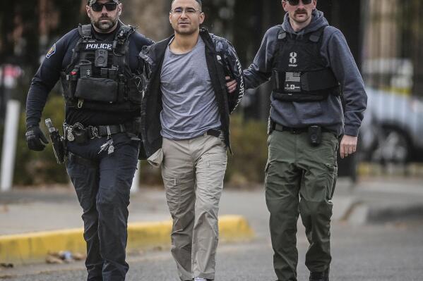 FILE - Solomon Peña, center, a Republican candidate for New Mexico House District 14, is taken into custody by Albuquerque, New Mexico, Police officers, Jan. 16, 2023, in southwest Albuquerque. Peña has been indicted on federal charges including interference with the electoral process in connection with a series of drive-by shootings at the homes of state and local lawmakers in Albuquerque, according to a grand jury indictment that was unsealed Wednesday, May 31. (Roberto E. Rosales/The Albuquerque Journal via AP, File)