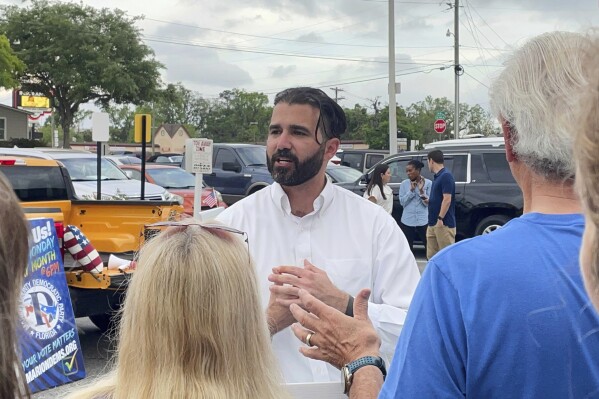 Josh Weil talks to a group of supporters during a Get Out the Vote event in Ocala, Fla., Monday, March 31, 2025. (AP Photo/Stephany Matat, file)