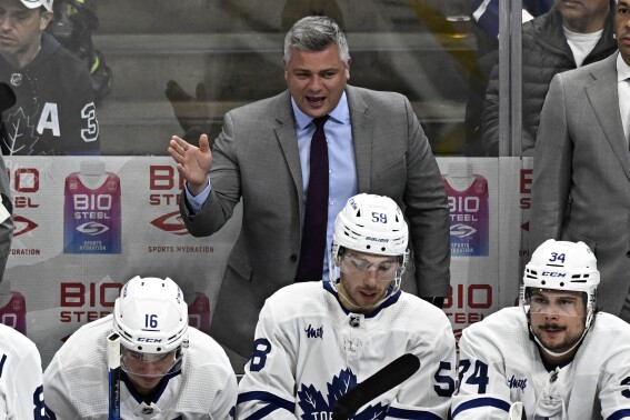 FILE - Toronto Maple Leafs head coach Sheldon Keefe, center, talks to his team during the third period of an NHL hockey game against the Anaheim Ducks in Anaheim, Calif., Sunday, Oct. 30, 2022. The Toronto Maple Leafs have signed coach Sheldon Keefe to a multiyear contract extension. The deal with the 42-year-old Keefe announced Wednesday, Aug. 30, 2023, wasn't a surprise, considering new general manager Brad Treliving hinted about it last week. (AP Photo/Alex Gallardo, File)