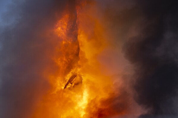 Fire and smoke rise out of the Old Stock Exchange, Boersen, in Copenhagen, Denmark, Tuesday, April 16, 2024. One of Copenhagen’s oldest buildings is on fire and its iconic spire has collapsed. The copper roof of the 17th-century Old Stock Exchange, or Boersen, that was once Denmark’s financial center, was engulfed in flames Tuesday. (Ida Marie Odgaard/Ritzau Scanpix via AP)