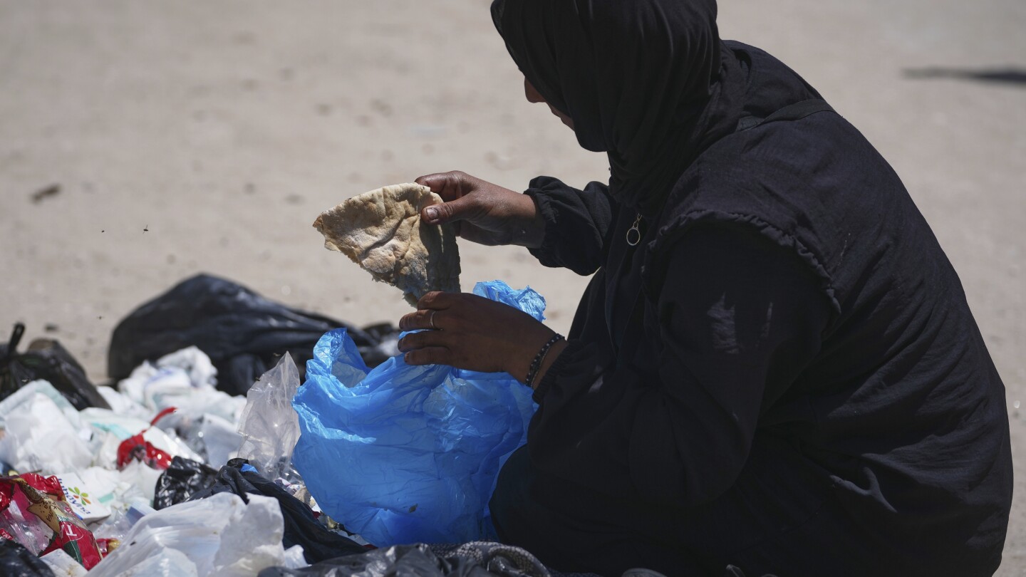 A family digs through trash for bits of food, showing Gaza's growing desperation