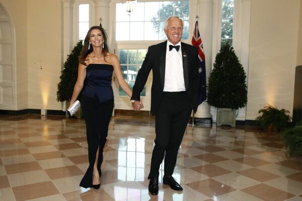 Golfer Greg Norman, right, and wife Kirsten Kutner arrive for a State Dinner with Australian Prime Minister Scott Morrison and President Donald Trump at the White House, Friday, Sept. 20, 2019, in Washington. (AP Photo/Patrick Semansky)