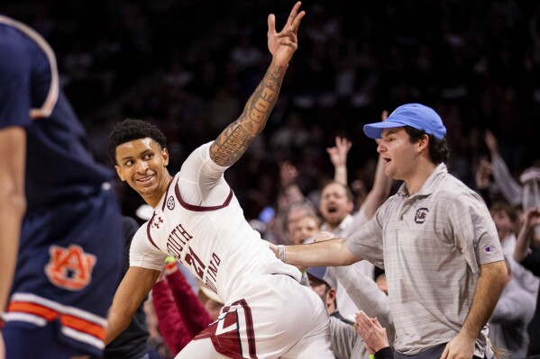 South Carolina guard Arden Conyers (21) celebrates a 3-point basket against the Auburn during the second half of an NCAA college basketball game on Saturday, Jan. 11, 2025, in Columbia, S.C. (AP Photo/Scott Kinser)