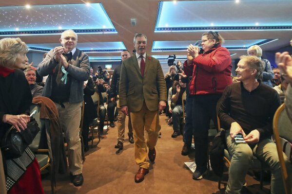 Brexit Party leader Nigel Farage, centre, is welcomed by supporters, during an event at the Washington Central Hotel, in Workington, England, Wednesday, Nov. 6, 2019. Britain goes to the polls on Dec. 12. (Danny Lawson/PA via AP)