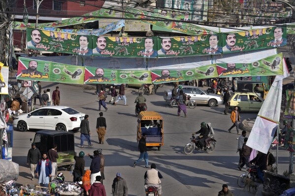 Banners of election candidates from political parties are displayed at a market downtown in Rawalpindi, Pakistan, Tuesday, Feb. 6, 2024. More than 120 million voters in Pakistan get to elect a new parliament on Thursday. The elections are the twelfth in the country's 76-year history, which has been marred by economic crises, military takeovers and martial law, militancy, political upheavals and wars with India. (AP Photo/Anjum Naveed)