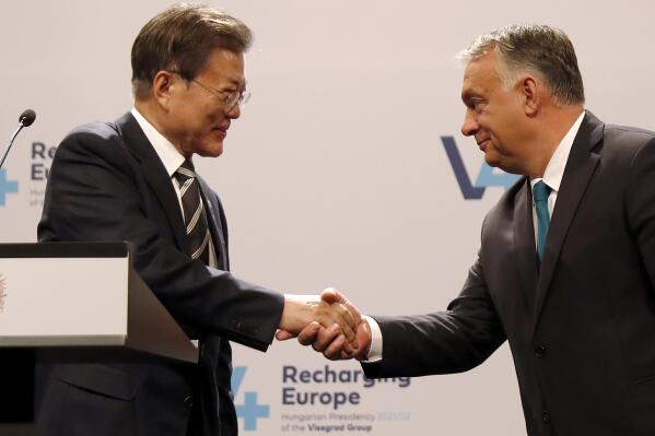 South Korea's President Moon Jae-in, left, shakes hands with Hungarian Prime Minister Viktor Orban during statements after a meeting of central Europe's informal body of cooperation called the Visegrad Group or V4, in Budapest, Hungary, Thursday, Nov. 4, 2021. (AP Photo/Laszlo Balogh)