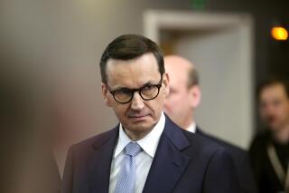 FILE - Poland's Prime Minister Mateusz Morawiecki leaves after an EU summit at the European Council building in Brussels, on March 24, 2023. Morawiecki flew Tuesday, April 11, to the United States for meetings aimed at strengthening the economic and defense cooperation of the two nations. (AP Photo/Olivier Matthys, Pool, File)