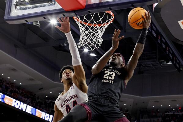 Texas A&M guard Tyrece Radford (23) shoots around Auburn center Dylan Cardwell (44) during the first half of an NCAA college basketball game Wednesday, Jan. 25, 2023, in Auburn, Ala.. (AP Photo/Butch Dill)