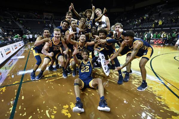 UC Irvine players celebrate after defeating No. 21 Oregon 69-56 in an NCAA college basketball game Friday, Nov. 11, 2022, in Eugene, Ore. (AP Photo/Andy Nelson)
