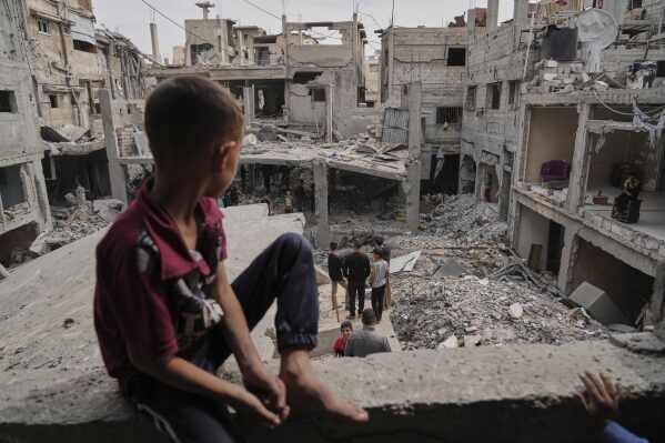 Palestinians inspect the rubble of the Al-Lahham family's home, destroyed by Israeli airstrikes in Khan Younis, Gaza Strip, on Thursday, May 15, 2025. (AP Photo/Abdel Kareem Hana)