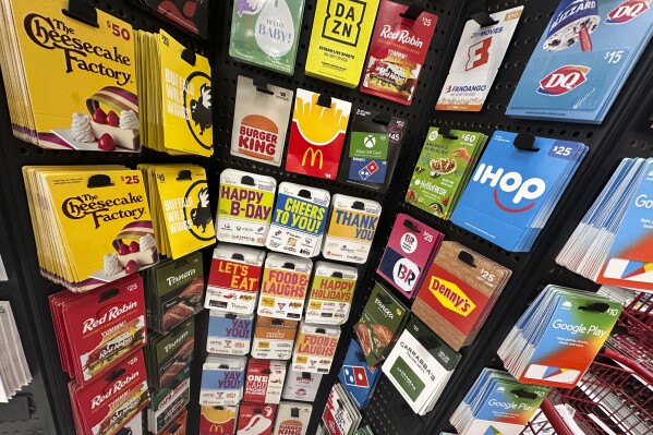 Gift cards are displayed at a Target store, in New York, Thursday, Dec. 21, 2023. Americans are expected to spend nearly $30 billion on gift cards this holiday season, according to the National Retail Federation. Restaurant gift cards are the most popular, making up one-third of those sales. (AP Photo/Richard Drew)