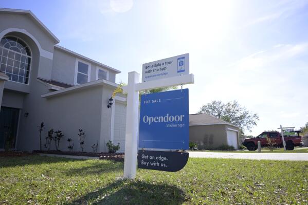 File - Real estate signs are posted outside homes for sale, Tuesday, Feb. 21, 2023, in Valrico, Fla. On Thursday, the National Association of Realtors reports on sales of existing homes in March. (AP Photo/Phelan M. Ebenhack, File)