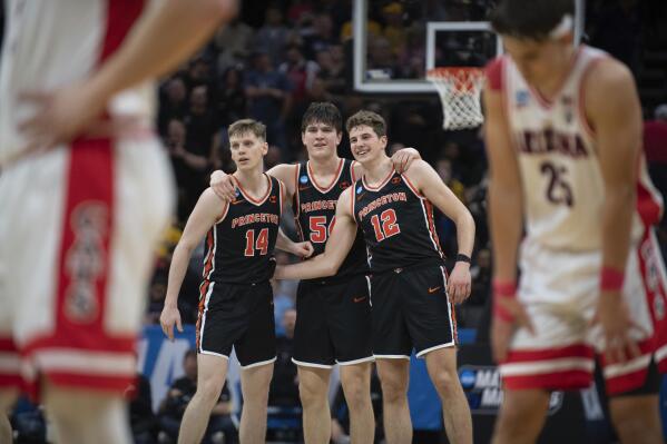 Princeton guard Matt Allocco (14) forward Zach Martini (54) and forward Caden Pierce (12) and teammates embrace in the final seconds of the second half of a first-round college basketball game against Arizona in the NCAA Tournament in Sacramento, Calif., Thursday, March 16, 2023. Princeton won 59-55. (AP Photo/José Luis Villegas)