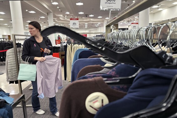 FILE - A woman shops at a retail store in Schaumburg, Ill., Dec. 18, 2023. On Friday, June 26, 2024, the Commerce Department issues its report on consumer spending for June. (ĢӰԺ Photo/Nam Y. Huh, File)