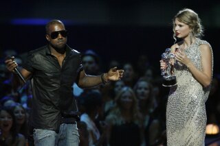 FILE - In this Sept. 13, 2009 file photo, singer Kanye West takes the microphone from singer Taylor Swift as she accepts the "Best Female Video" award during the MTV Video Music Awards in New York. Swift may have ended her feud with Katy Perry but the one with Kanye West seems simply not to want to die. New leaked video clip of the entire four-year-old phone call between the rapper and pop superstar about his controversial song "Famous" have been posted online and further complicate the picture of what happened.(AP Photo/Jason DeCrow, File)