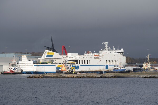 The Marco Polo ferry is towed into the port of Karlshamn, Sweden, Thursday, Nov. 2, 2023. A ferry that ran aground last month off southeastern Sweden and started leaking oil into the Baltic Sea, arrived Thursday at a Swedish harbor where its tanks will be emptied, Swedish media reported. (Ola Torkelsson/TT News Agency via AP)