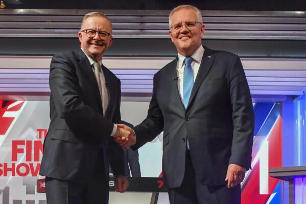 Australian Prime Minister Scott Morrison, right, and Australian opposition leader Anthony Albanese shake hands ahead of the leaders' debate in Sydney, Australia, on May 11, 2022. Australians go to the polls on Saturday, May 21, following a six-week election campaign that has focused on pandemic-fueled inflation, climate change and fears of a Chinese military outpost being established less than 2,000 kilometers (1,200 miles) off Australia’s shore.(Mick Tsikas/Pool Photo via AP)