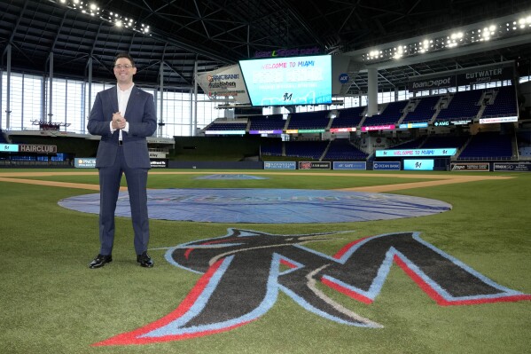 Peter Bendix, Miami Marlins president of baseball operations, poses for a photograph on the field at loanDepot Park after being introduced at a news conference, Monday, Nov. 13, 2023, in Miami. (AP Photo/Lynne Sladky)